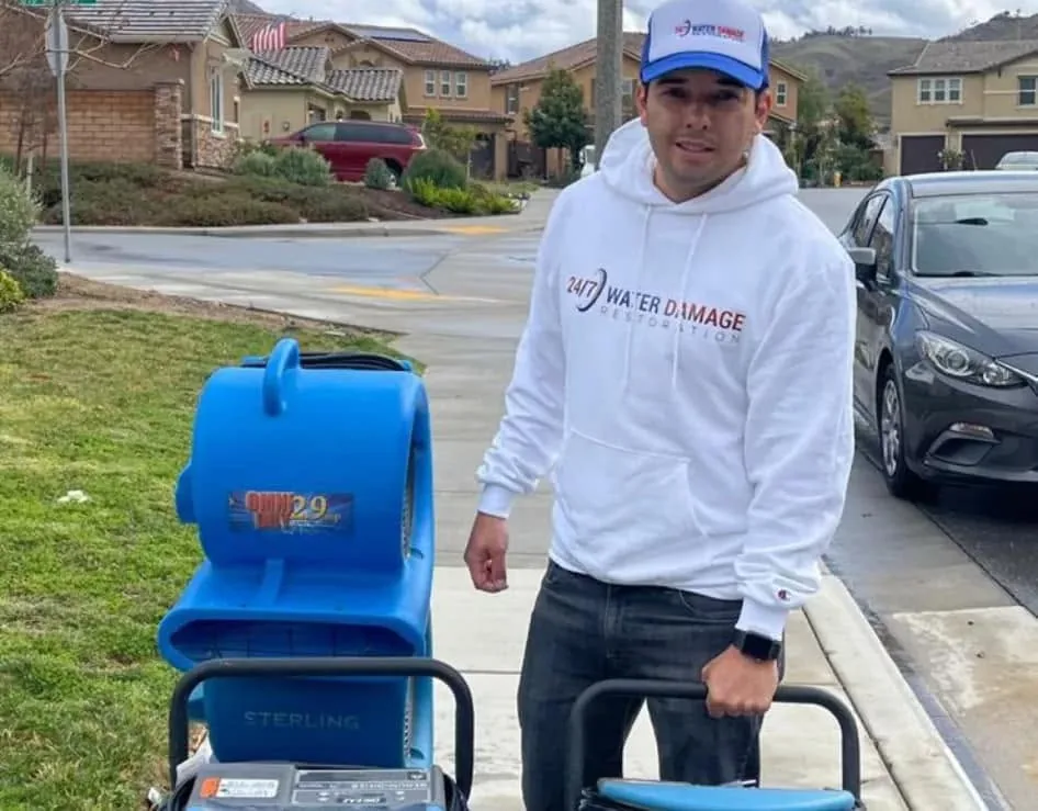 Los Angeles water damage restoration technician using professional drying equipment